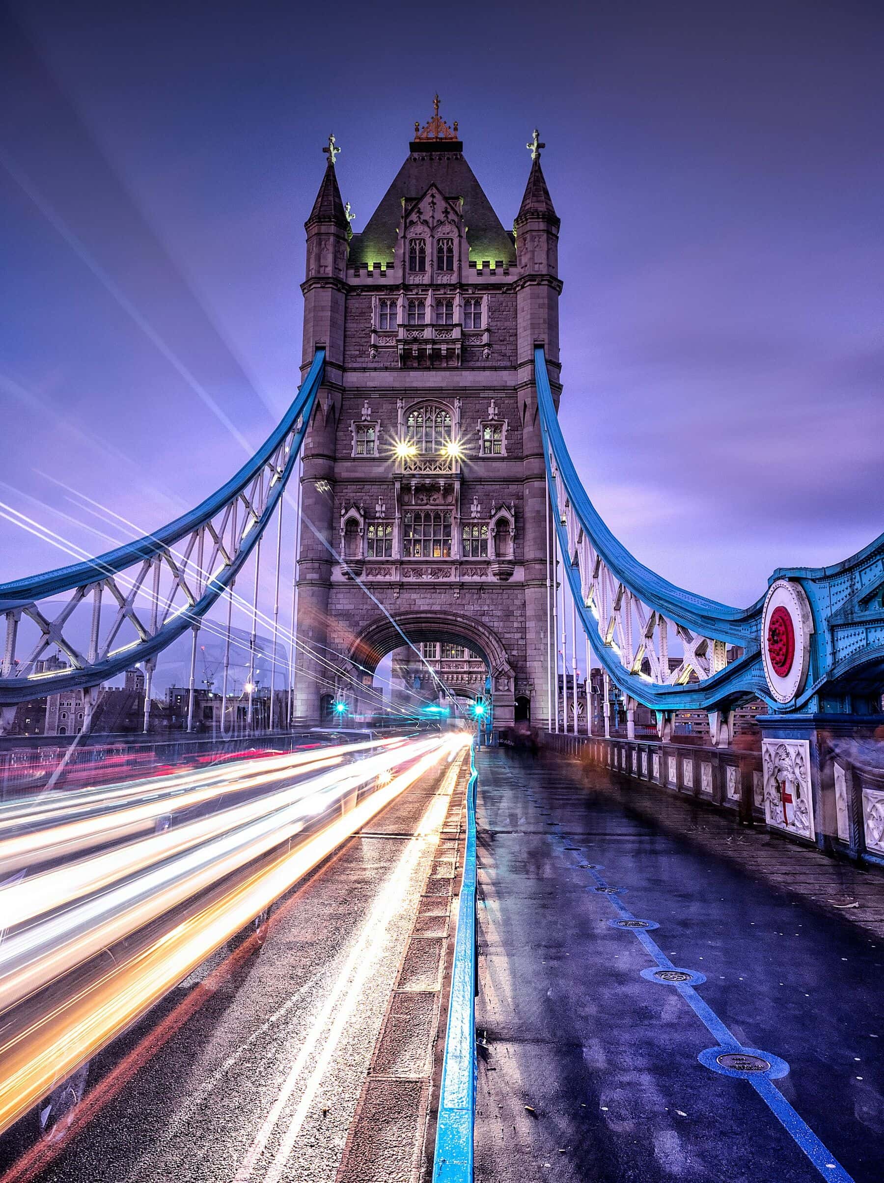 Tower Bridge at blue hour, with the light of traffic crossing it in long streaks.